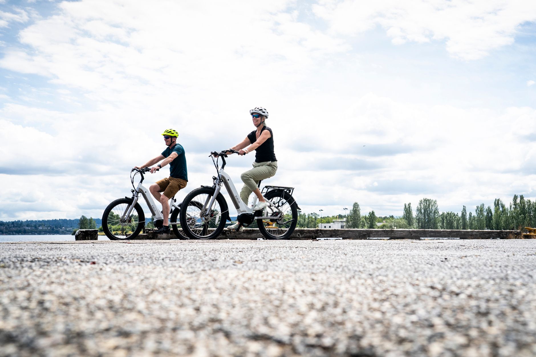 Cyclist with a touring e-bike stopped on a lakeside path