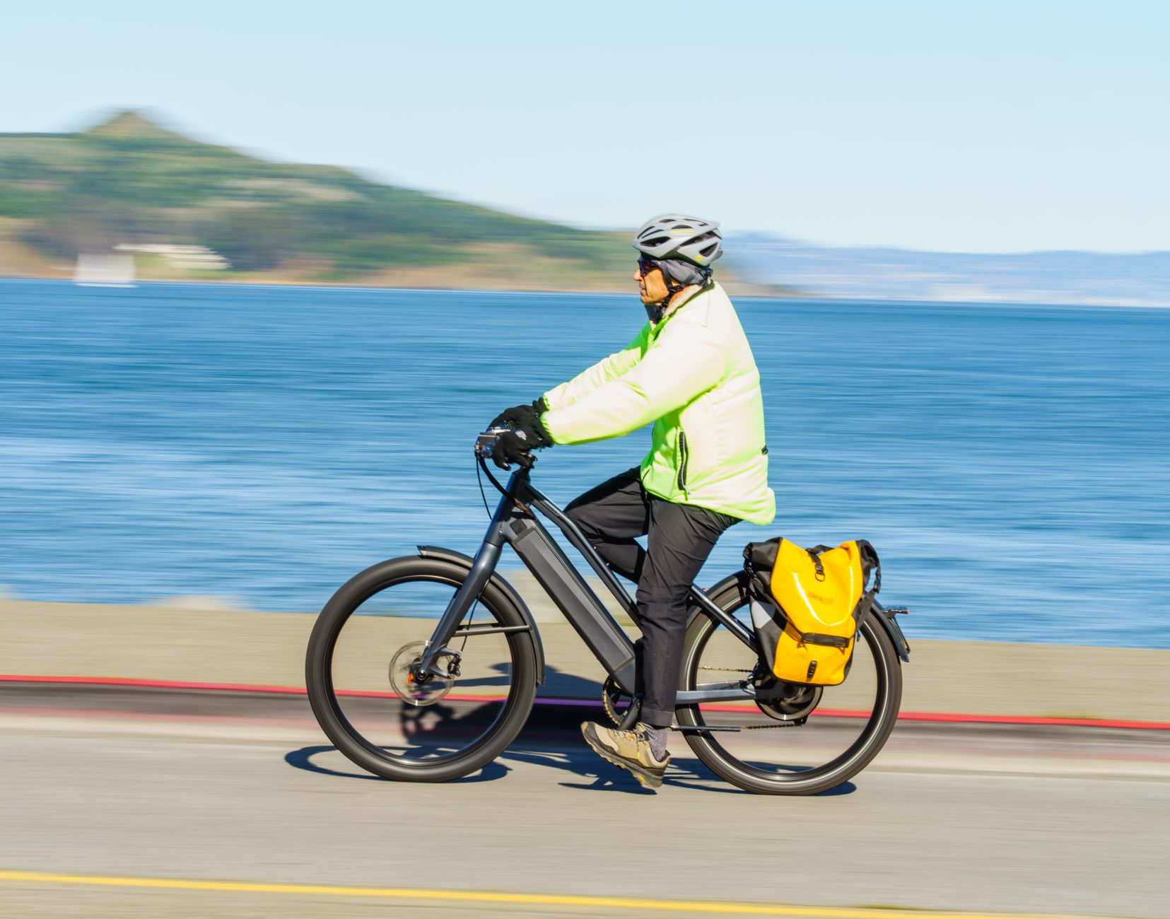 Loaded panniers hanging from an e-bike's rear rack